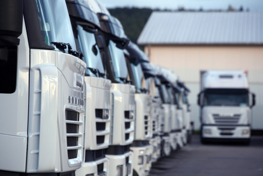 Commercial vehicle fleet parked at a transport depot, representing investment, fleet financing, residual value risk and operational performance in the UK vehicle hire sector.